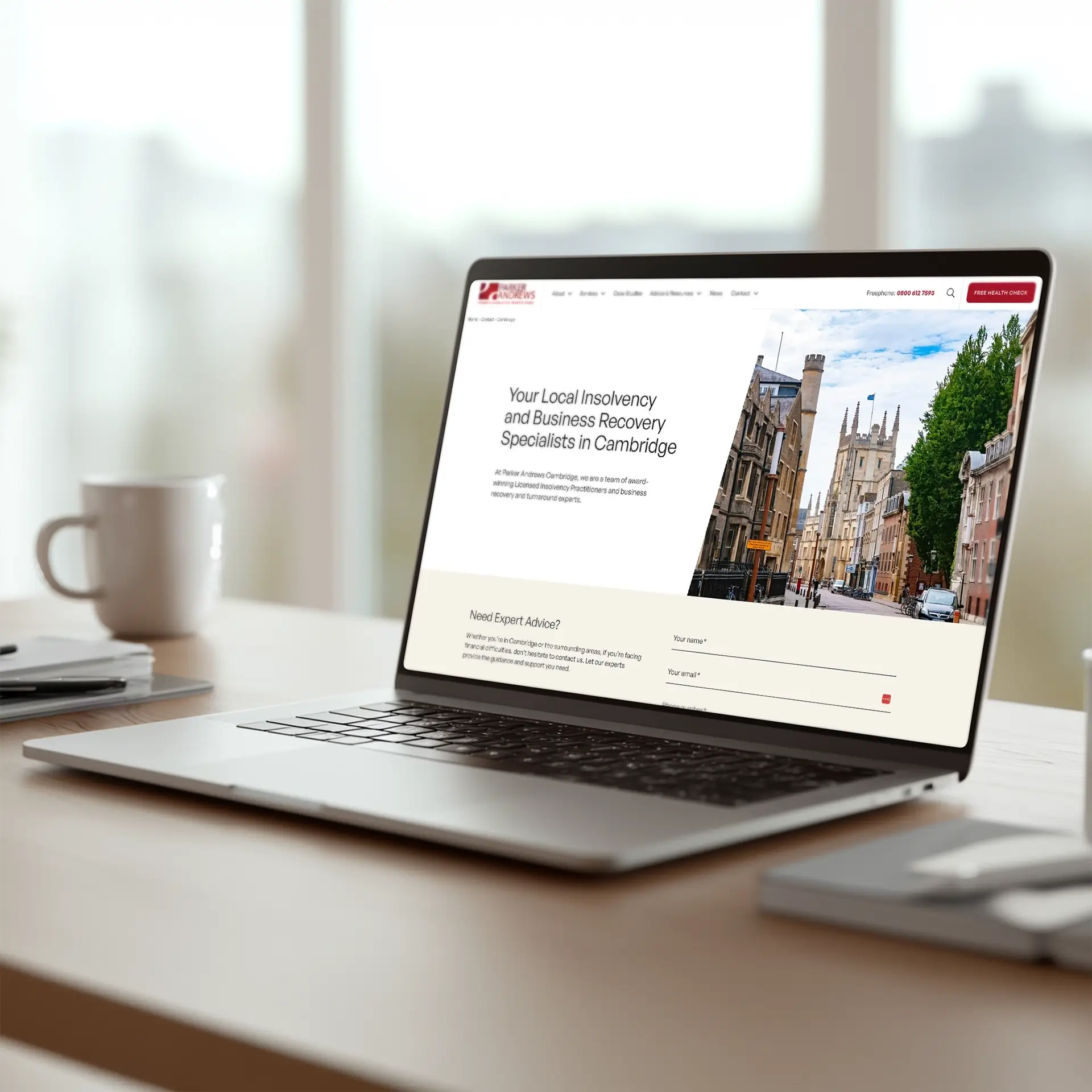 Parker Andrews mockup of a laptop sitting on a desk showing the new contact page design